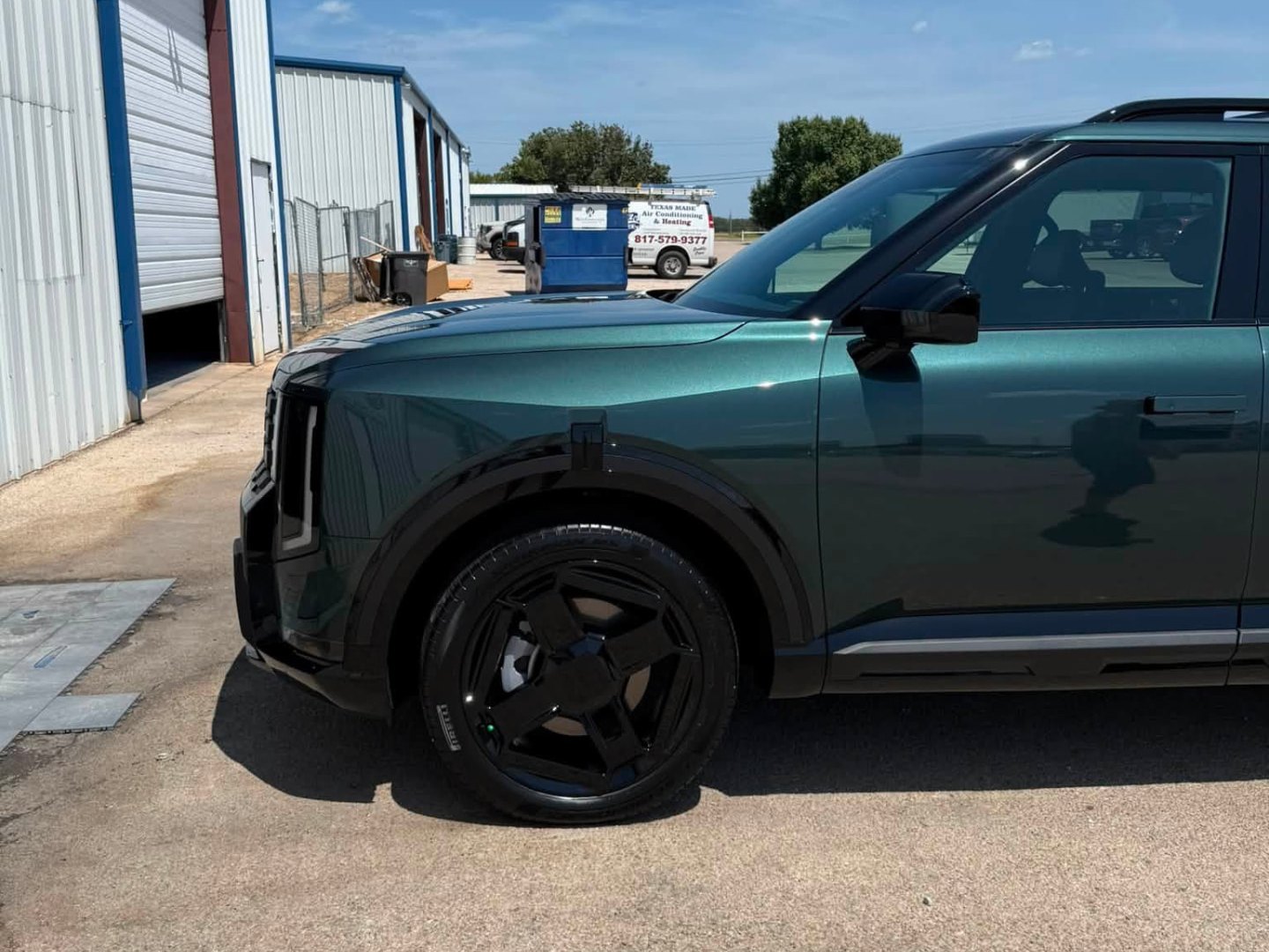 Deep green Kia EV9 with glossy paint outside the A1CC shop